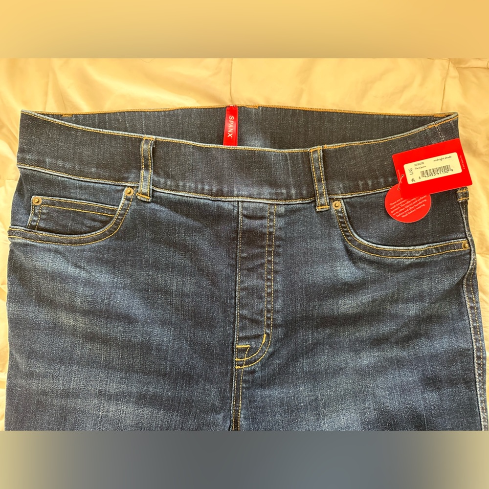 NWT SPANX flare jeans. Darker blue. Never been worn.